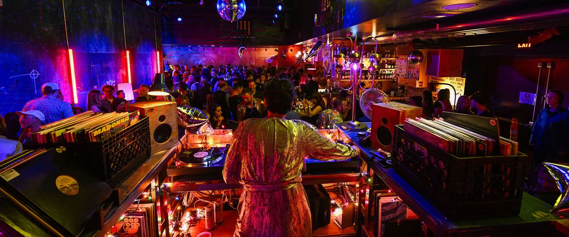 dj and partygoers at Superfrico glitter lounge